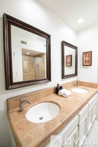 A bathroom with a sink and mirror.