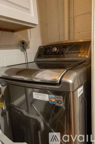 A front-loading dishwasher with a digital display and control panel.