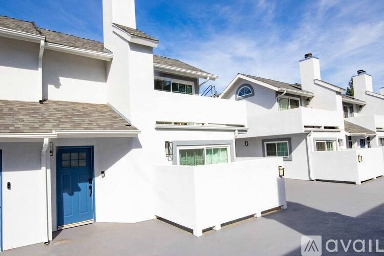 A white house with a blue door and windows.