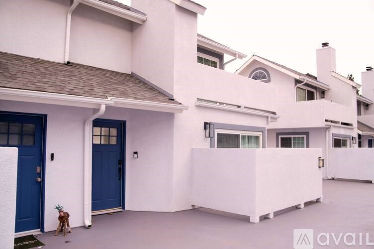 A white house with a blue door and windows.