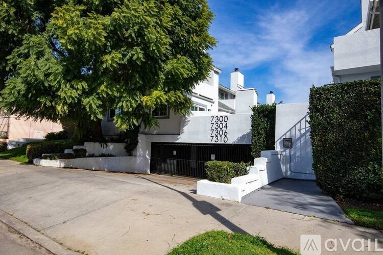 A white house with the numbers 7300 and 7306 on it.