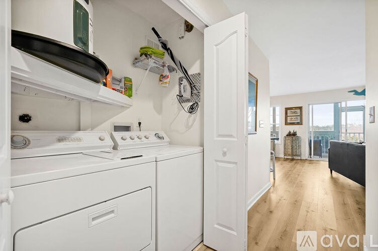 A small laundry room with a washer and dryer.