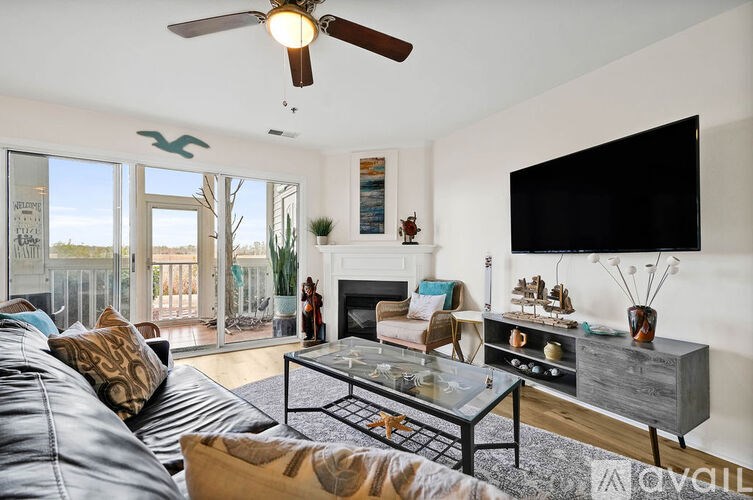 A living room with a couch, a coffee table, and a television.
