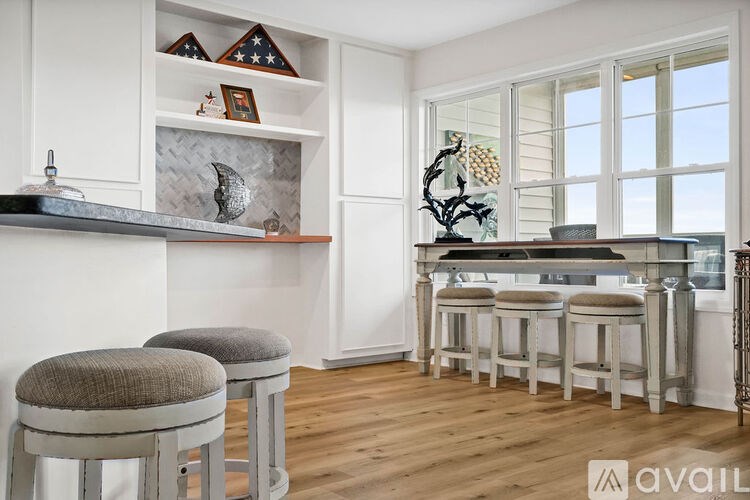 A kitchen with a bar area and stools.