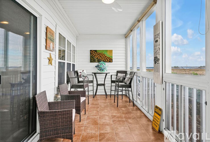 A sunny patio with a table and chairs.