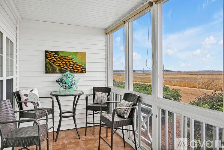 A table with chairs and a painting on the wall.