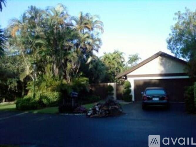 A house with a car parked in front of it.