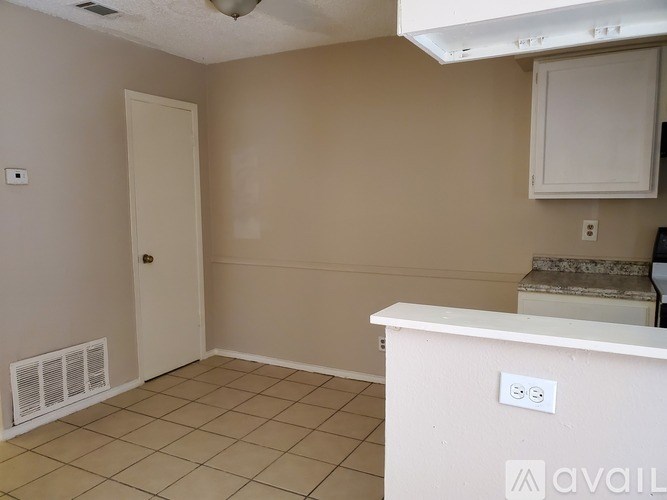 A room with a white door and a white counter.
