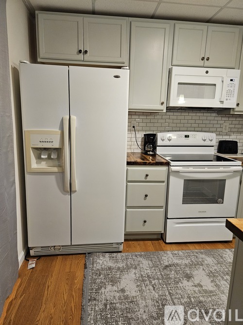 A white fridge and oven in a kitchen.