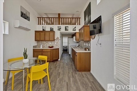 A kitchen with a yellow table and chairs.