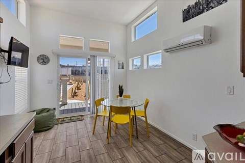 A living room with a yellow table and chairs.