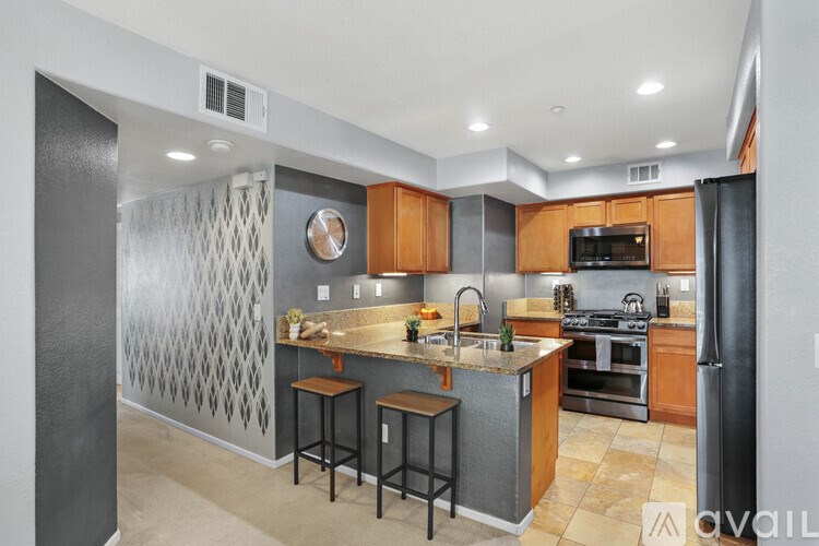 A kitchen with a bar stool and a countertop.