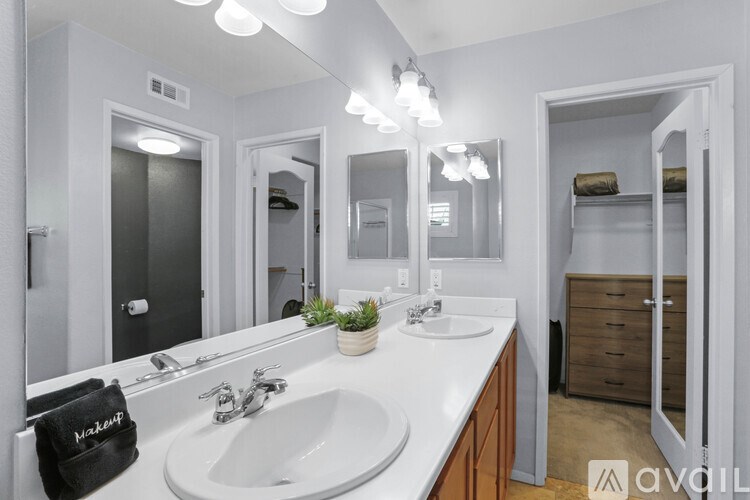 A bathroom with a white sink and a mirror above it.