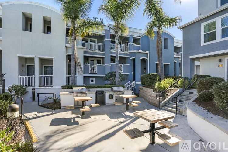 A sunny day at the outdoor seating area of a modern apartment complex.