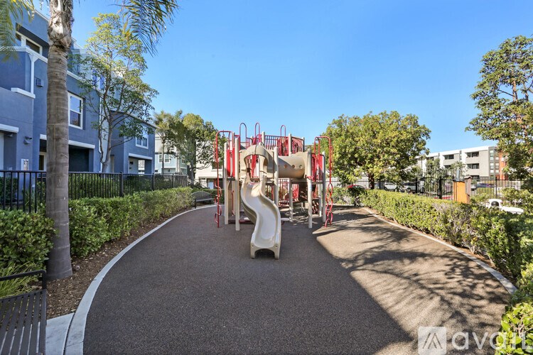 A playground with a slide and a climbing frame.