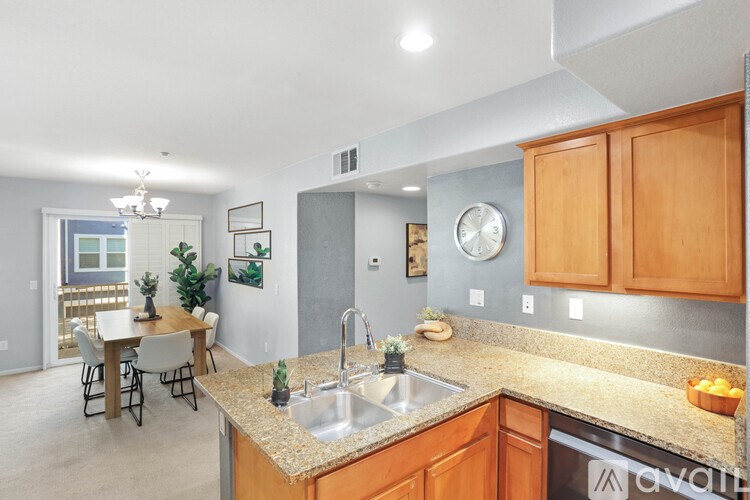 A kitchen with wooden cabinets and a granite countertop.
