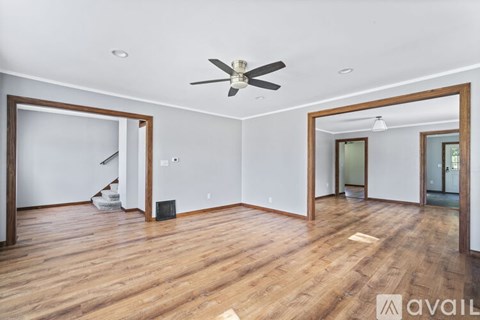 A room with wooden floors and a ceiling fan.