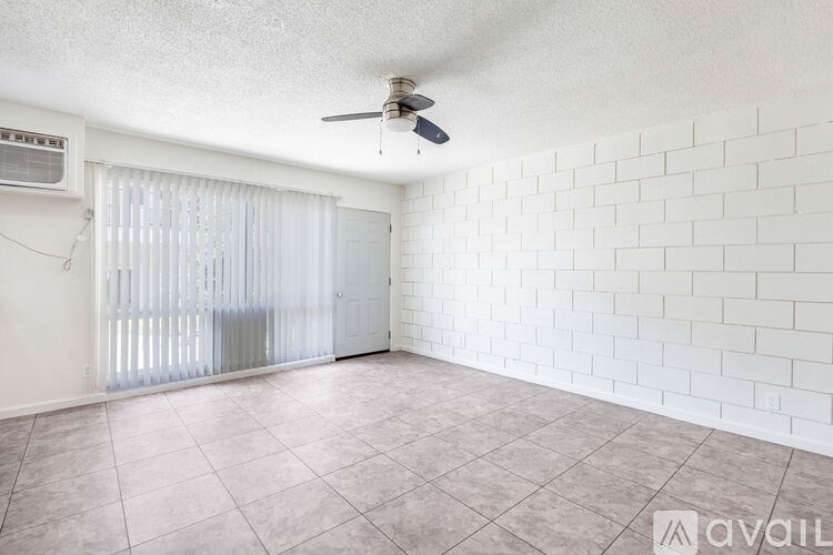 A room with a ceiling fan and a sliding door.