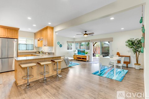 A kitchen with a bar and a dining table.