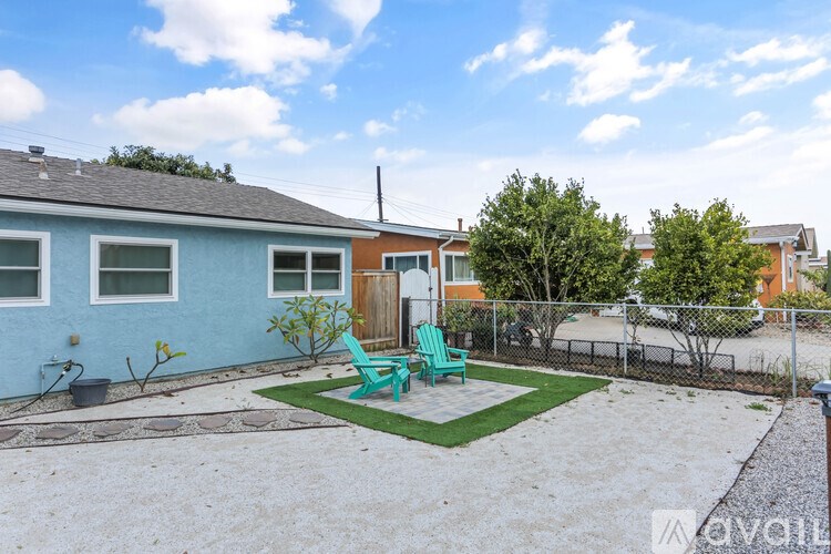 A blue house with a green chair in front of it.