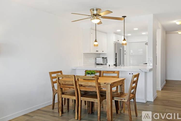A dining room with a table and chairs.