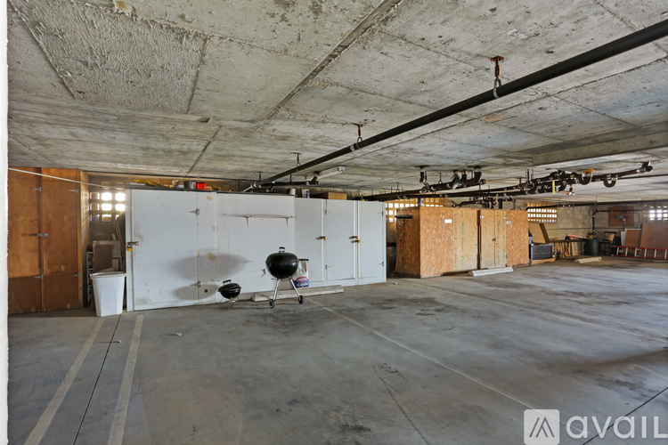 A large empty warehouse with a BBQ grill in the middle.