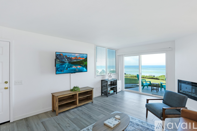 A living room with a wooden bench and a painting on the wall.