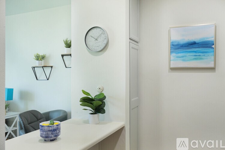A white table with a plant and a basket on it.