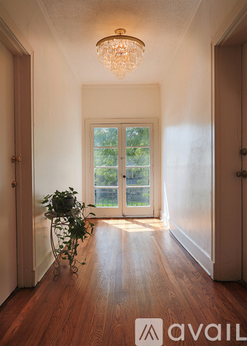 A room with a wooden floor and a chandelier.
