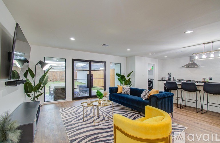 A living room with a zebra print rug and a yellow chair.