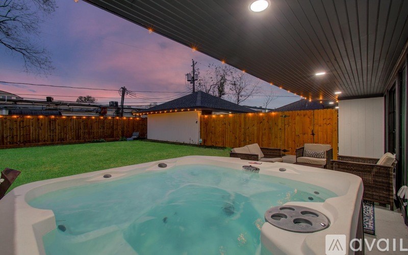 A hot tub is in the middle of a backyard.
