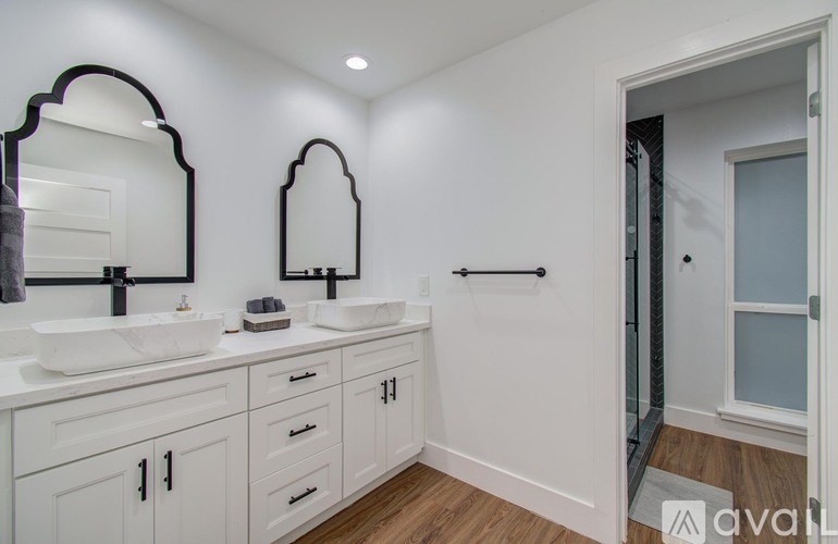 A bathroom with two sinks and a mirror.