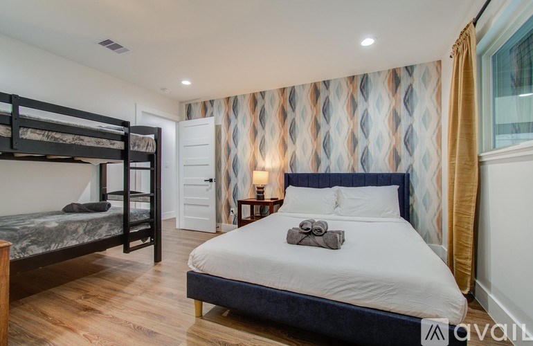 A bedroom with a large bed and a bunk bed.