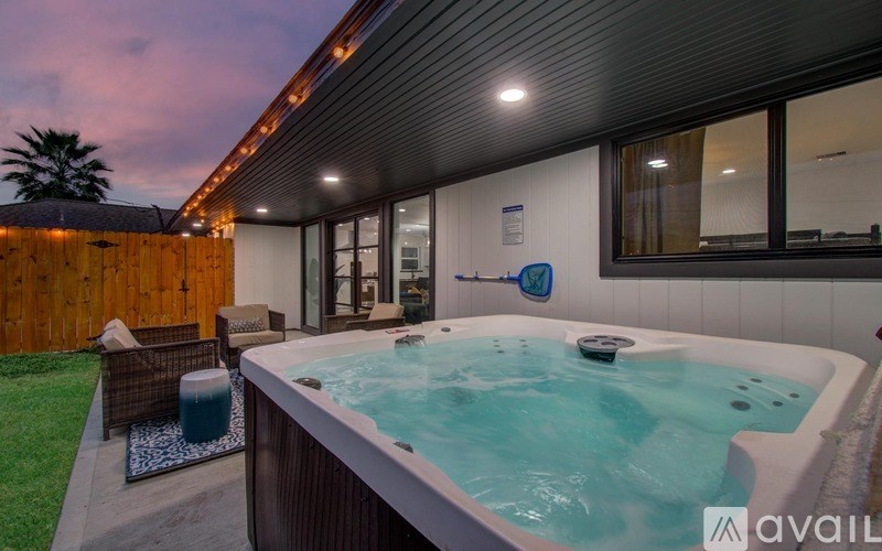 A hot tub is in the middle of a backyard.