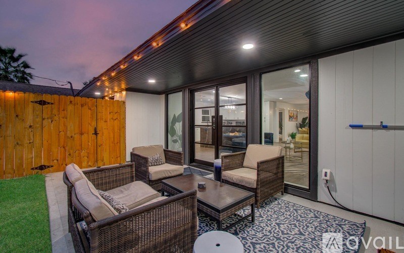 A patio with a table and chairs is set up outside.