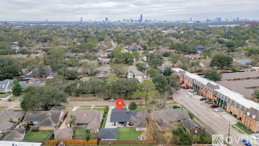 A red marker is placed on a house in a suburban neighborhood.