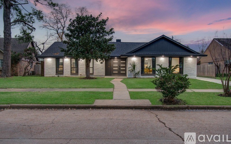 A house with a front yard and a driveway.