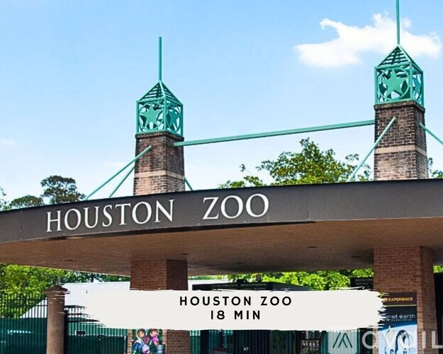 Houston Zoo sign with a clock tower in the background.