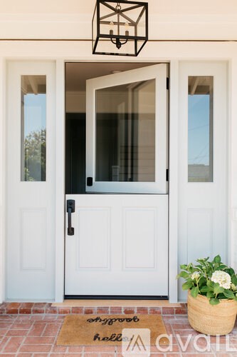 A white door with a glass window and a black handle.