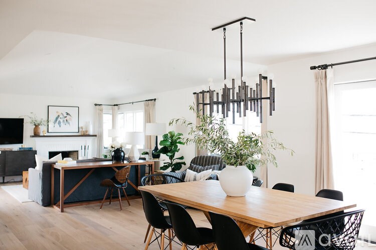 A modern dining room with a wooden table and chairs.