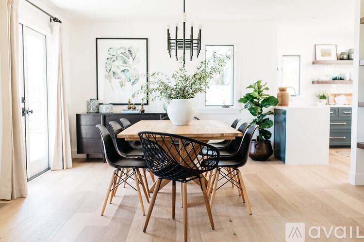 A dining room with a wooden table and chairs.