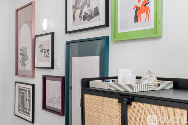 A wall with a collection of framed pictures on it.