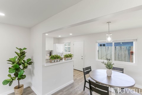 A dining room with a table and chairs.