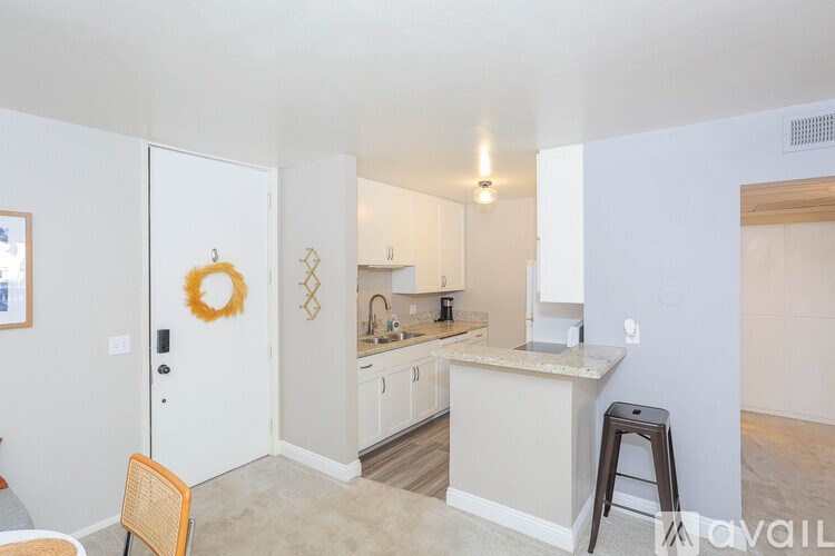 A kitchen with a white door and a wreath on it.