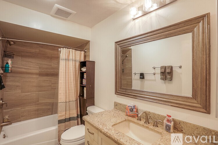 A bathroom with a sink, toilet, and bathtub.