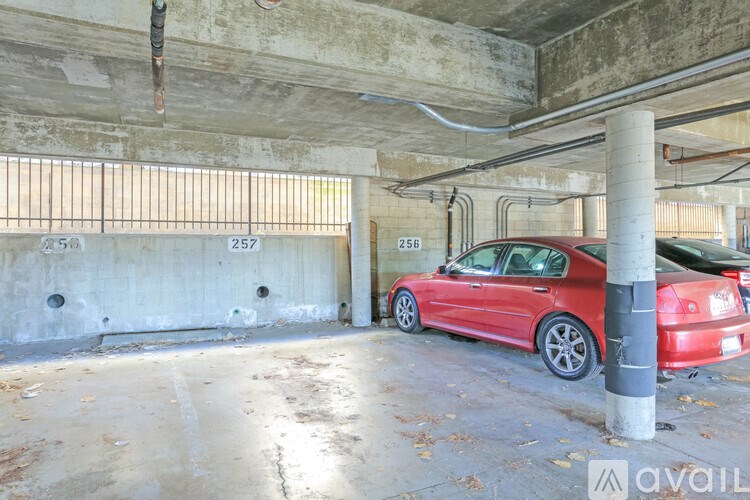 A red car is parked in a parking garage.