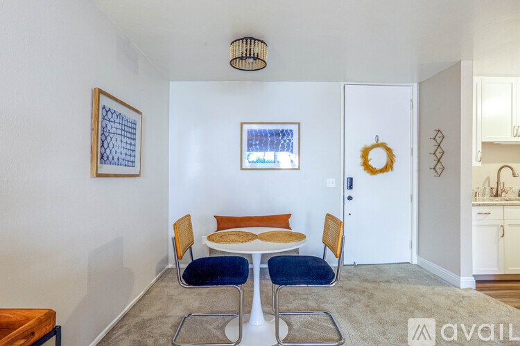 A dining room with a table and chairs.