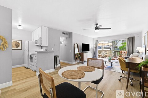 A dining room with a table and chairs.