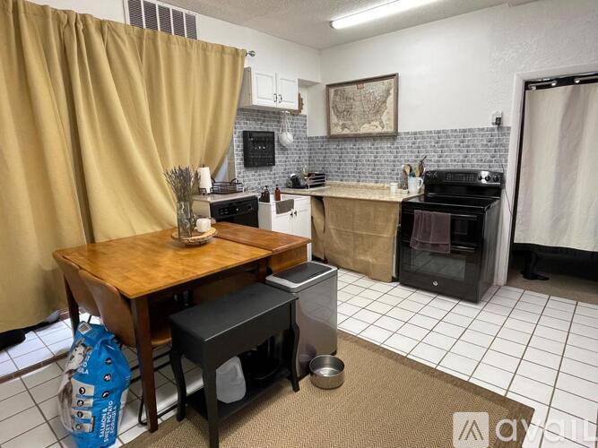 A kitchen with a wooden table and a black stove.
