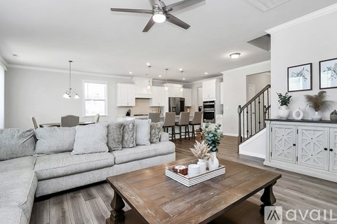 A modern living room with a grey sofa and a wooden coffee table.